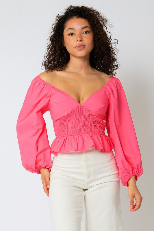 Peasant Sleeve V neck Smocked waistline Ruffle detail. Available in pink and black